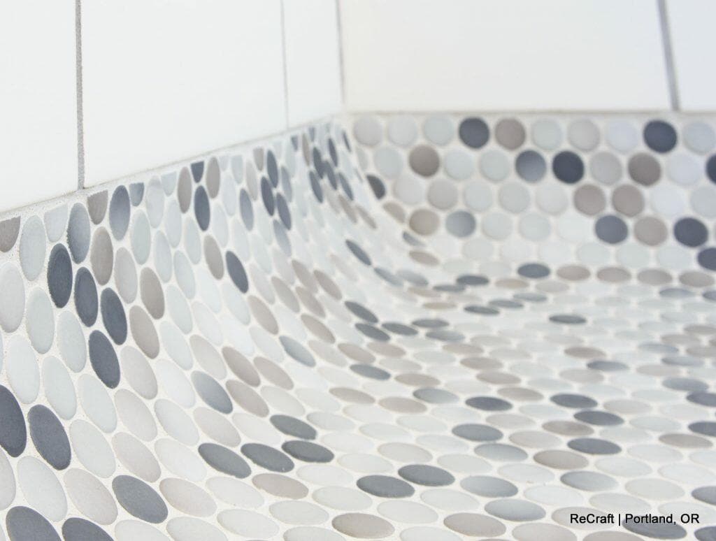 Close-up of a tiled surface featuring circular mosaic tiles in shades of grey, white, and beige. Logo and text in the lower right corner read "ReCraft | Portland, OR". Close-up of a tiled surface featuring circular mosaic tiles in shades of grey, white, and beige. Logo and text in the lower right corner read "ReCraft | Portland, OR".