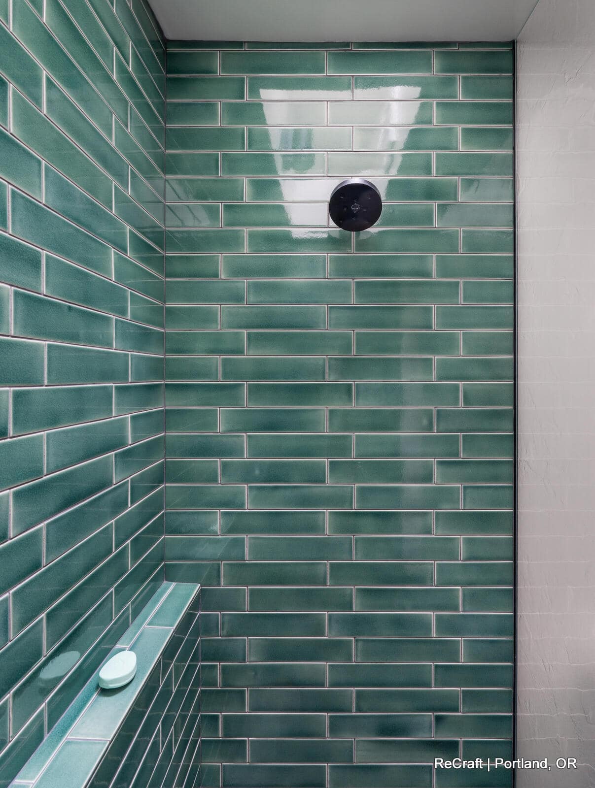 mcconnell - bathroom_shower3 Modern shower with green subway tile walls, overhead skylight, and sleek design, showcasing ReCraft Home Remodeling's bathroom renovation work in Portland.