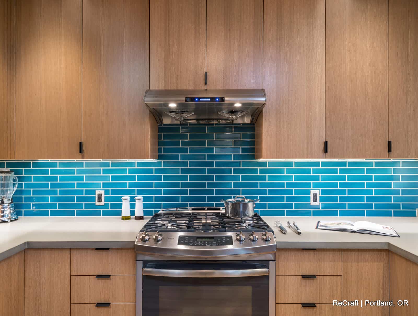 mcconnell - kitchen_oven Modern kitchen with stainless steel oven, turquoise backsplash, and wooden cabinetry, showcasing ReCraft Home Remodeling's design expertise in Portland.