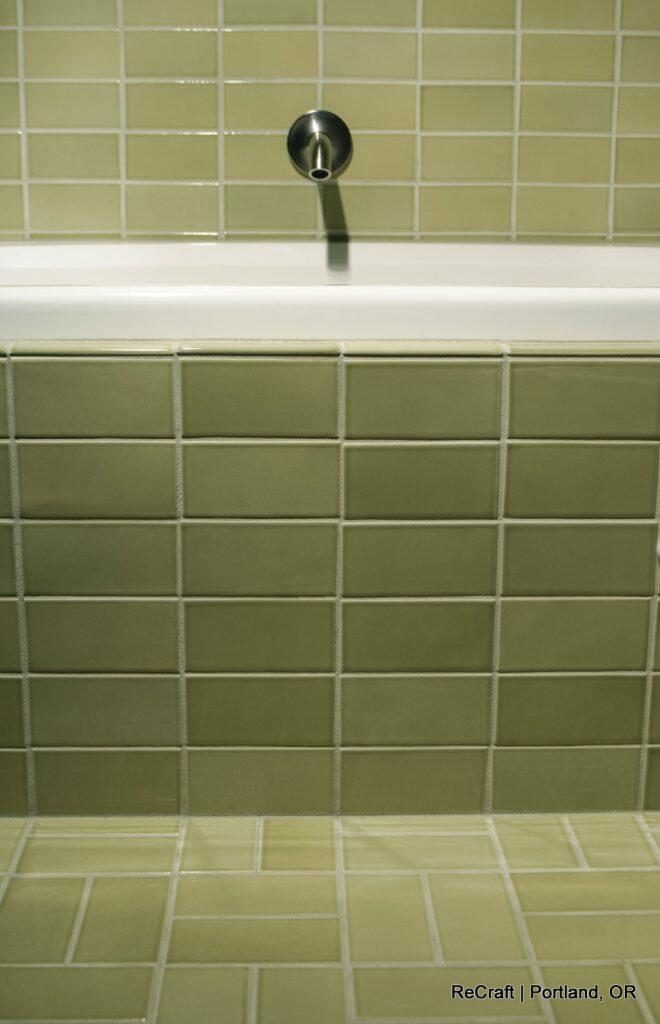 Green tiled bathtub with white tub edge and wall-mounted faucet, located in Portland, OR. Green tiled bathtub with white tub edge and wall-mounted faucet, located in Portland, OR.
