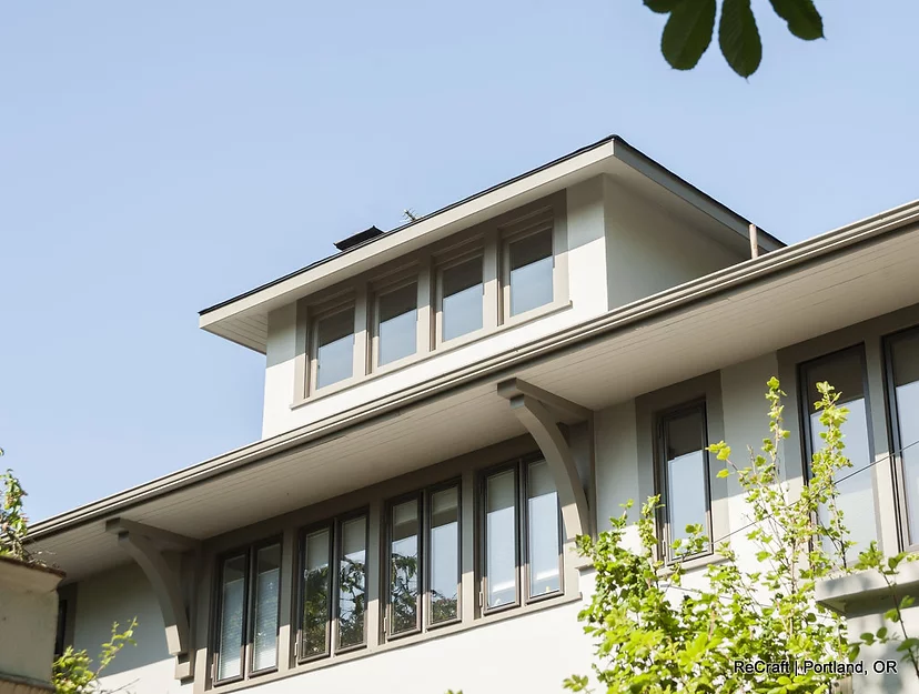 Modern architectural design of a home exterior featuring large windows and a flat roof, showcasing ReCraft Home Remodeling's expertise in home remodeling in Portland.