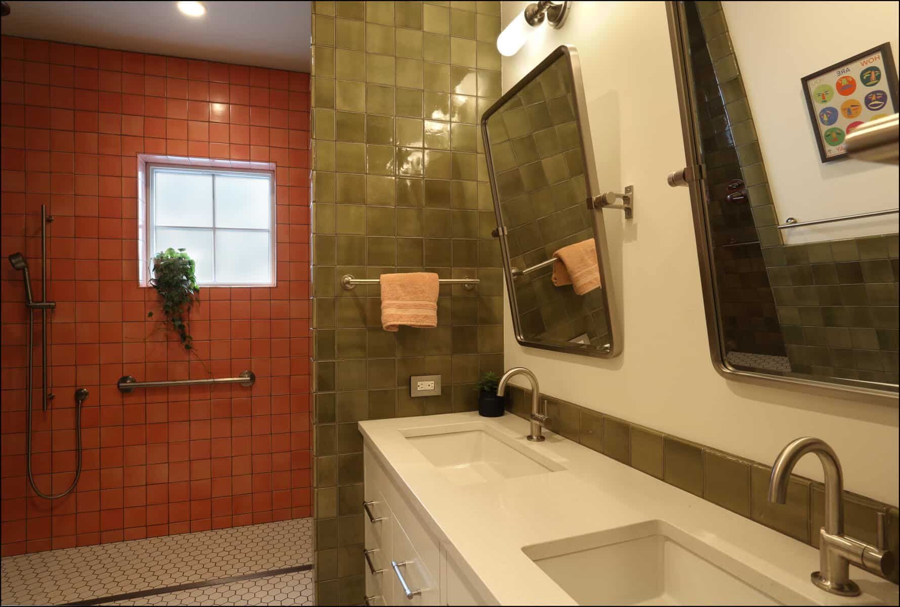Modern bathroom remodel featuring a dual sink vanity with sleek fixtures, adjacent to a walk-in shower with vibrant orange tiles and a window, showcasing ReCraft Home Remodeling's design expertise.