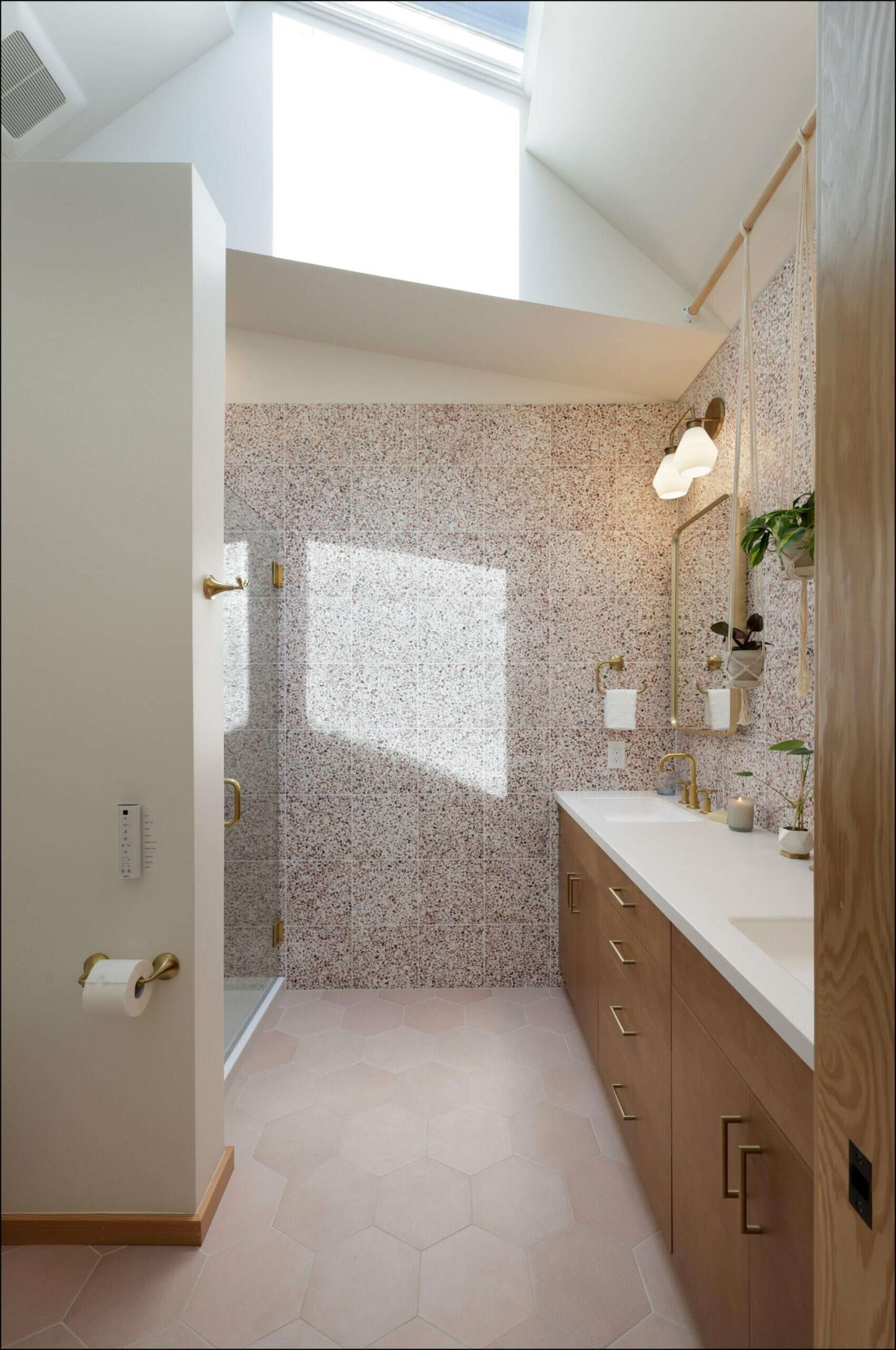 Modern Portland bathroom with hexagon tiles, natural wood cabinetry, and a skylight, showcasing ReCraft Home Remodeling's design expertise.