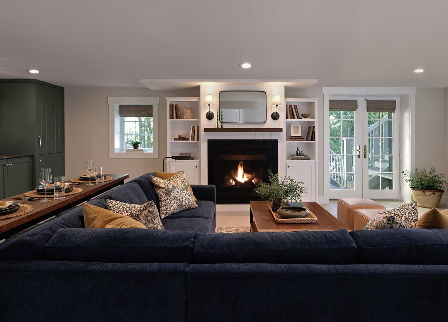 Cozy basement living area with a fireplace, modern furnishings, and a stylish couch, showcasing a remodeling project by ReCraft Home Remodeling Portland.