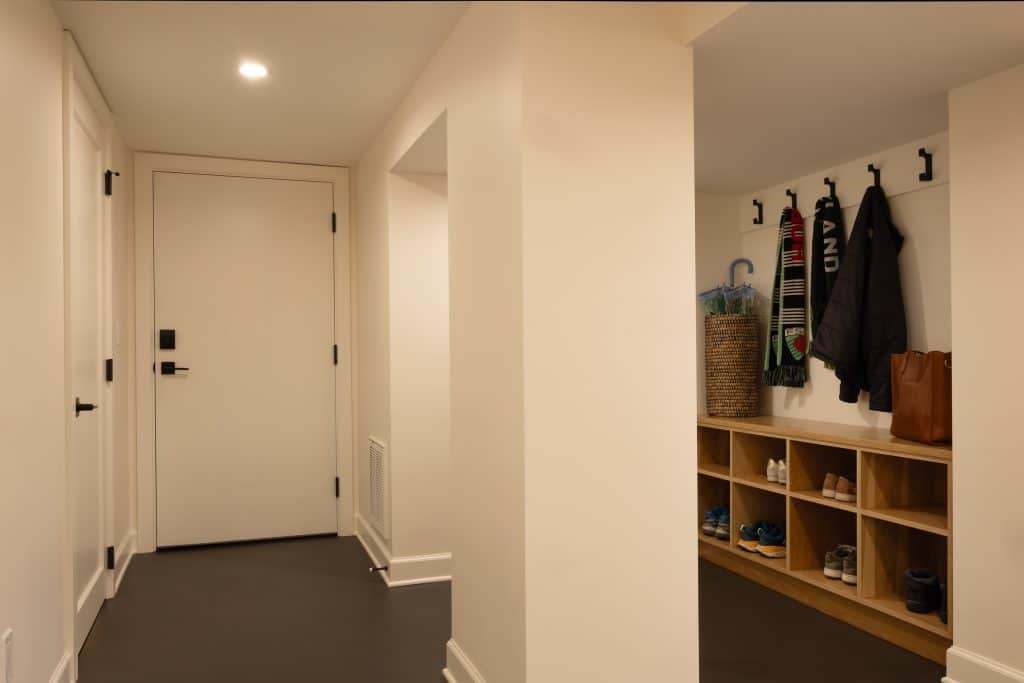 Basement entryway showcasing organized storage solutions, including coat hooks and cubbies, designed by ReCraft Home Remodeling for efficient space utilization in Portland homes.