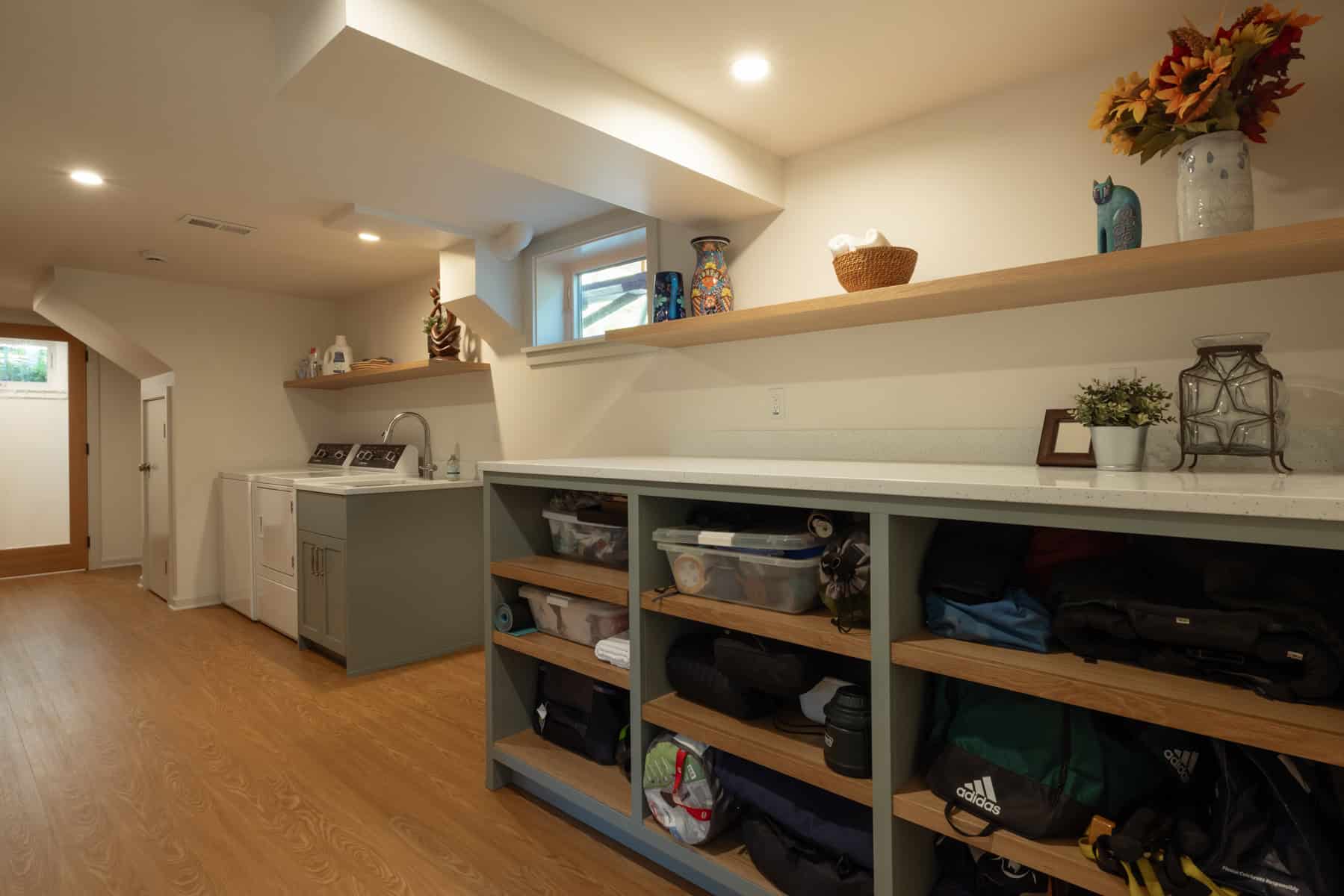 Finished basement renovation with laundry area and storage shelving in Portland, Oregon.